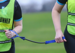 Blind runner and guide holding a tether.