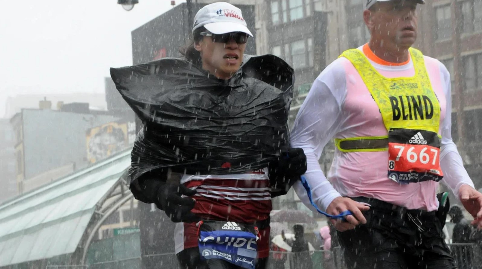 Vivienne Hau guiding visually impaired athlete Richard Hunter while it is snowing