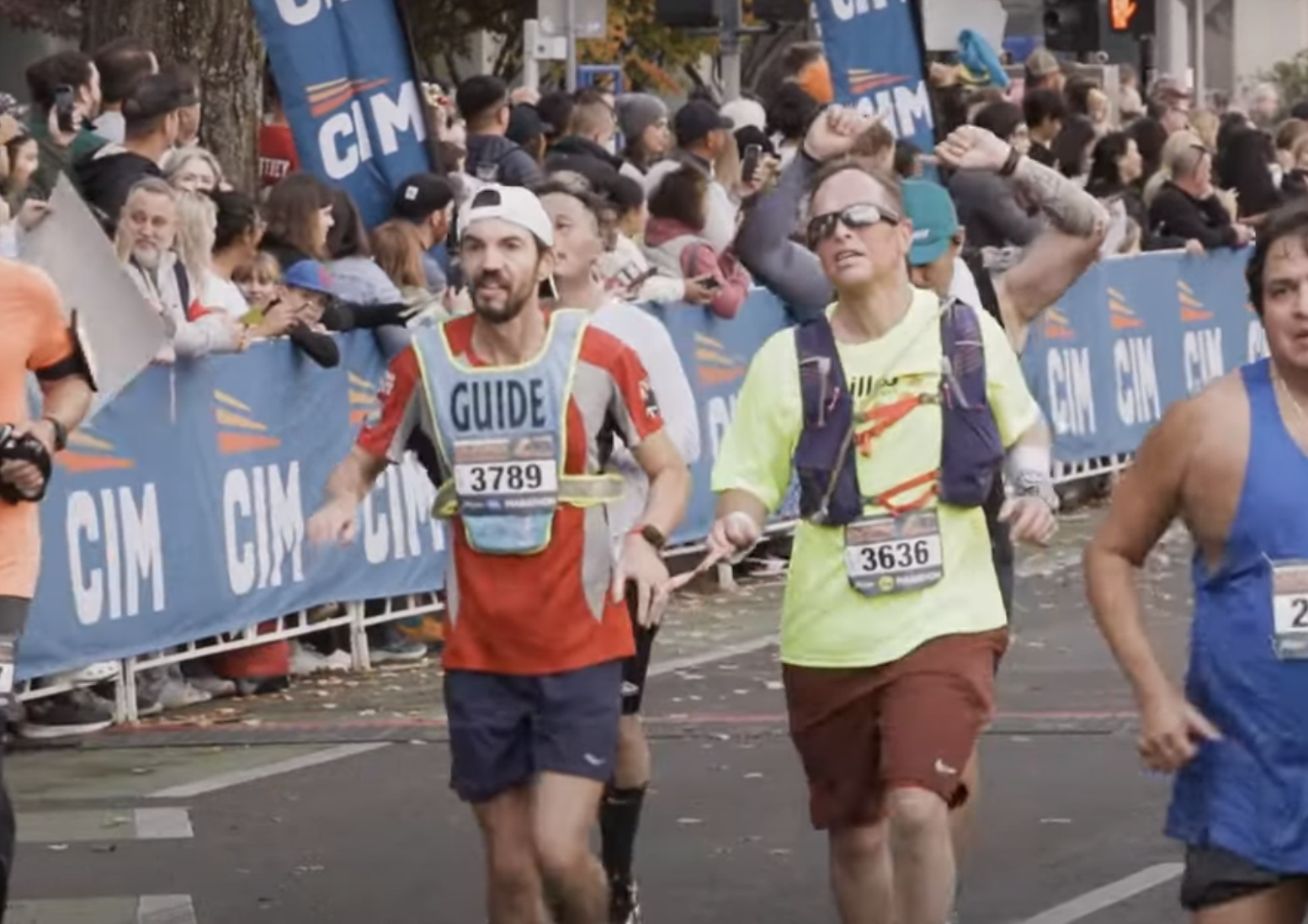 Visually Impaired runner Roger Oberholzer and his guide running with a tether at the California International Marathon.